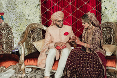 Indian bride putting groom his wedding ring. Indian bride putting groom his wedding ring.