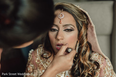 Indian bride getting her reception makeup on. Indian bride getting her reception makeup on.