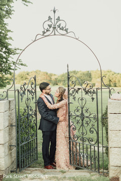Indian couple posing on an outdoor entrance. Indian couple posing on an outdoor entrance.