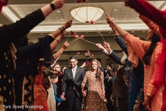 Indian bride and groom walking in to wedding reception. Indian bride and groom walking in to wedding reception.