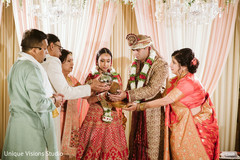 Indian couple holding the coconut used in wedding ritual. Indian couple holding the coconut used in wedding ritual.