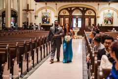 A couple of Indian wedding attendants walking down the aisle A couple of Indian wedding attendants walking down the aisle