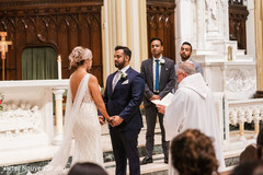 Indian couple reciting their vows in front of the priest Indian couple reciting their vows in front of the priest