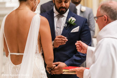 Indian groom about to put the wedding ring on Maharani's finger Indian groom about to put the wedding ring on Maharani's finger
