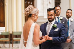 Indian bride putting a ring on the Indian groom's finger Indian bride putting a ring on the Indian groom's finger