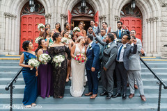 Indian newlyweds kissing while surrounded outside the church Indian newlyweds kissing while surrounded outside the church