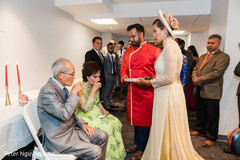 Indian couple serving a drink to Indian relatives Indian couple serving a drink to Indian relatives