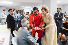 Indian couple offering a drink to Indian relatives Indian couple offering a drink to Indian relatives