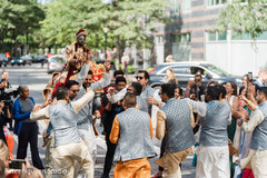 Indian groomsmen dancing in front of the riding Indian groom Indian groomsmen dancing in front of the riding Indian groom