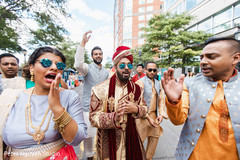 Indian relatives singing around the Indian groom during Baraat Indian relatives singing around the Indian groom during Baraat