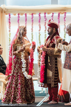 Indian couple about to exchange necklaces Indian couple about to exchange necklaces