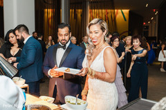 Indian couple being served some food Indian couple being served some food