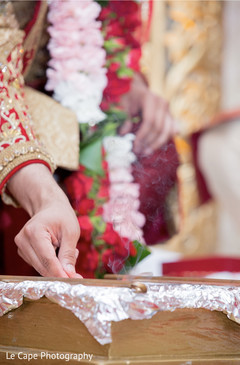 Indian groom lighting fire for Angi. Indian groom lighting fire for Angi.