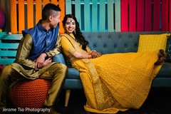 Indian bride and groom seating on their sangeet seats. Indian bride and groom seating on their sangeet seats.