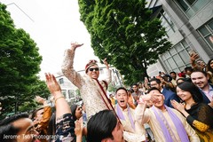 Indian groom lifted by groomsmen at baraat celebration. Indian groom lifted by groomsmen at baraat celebration.