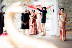 Indian bride entering to her wedding ceremony on her red lehenga. Indian bride entering to her wedding ceremony on her red lehenga.