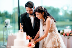 Indian couple cutting cake at reception party. Indian couple cutting cake at reception party.