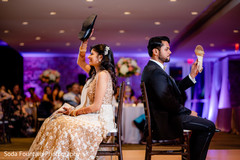 Indian couple playing the shoe game at reception. Indian couple playing the shoe game at reception.