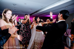 Indian wedding guests with bride and groom at reception dance. Indian wedding guests with bride and groom at reception dance.
