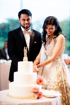 Indian wedding reception cutting cake moment. Indian wedding reception cutting cake moment.