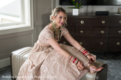 Maharani putting on her golden anklets. Maharani putting on her golden anklets.