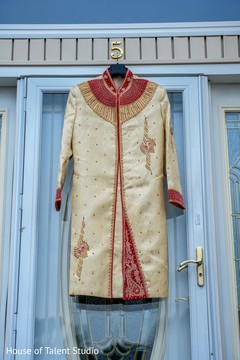 The beige and red sherwani to be worn by the Indian groom The beige and red sherwani to be worn by the Indian groom