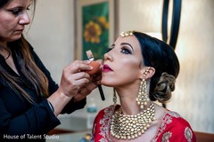 Indian bride getting her make up finished Indian bride getting her make up finished