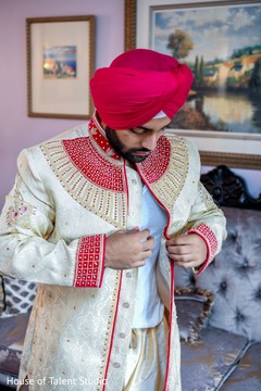 Indian groom putting his sherwani jacket on Indian groom putting his sherwani jacket on