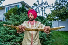 Indian groom showing his ceremonial sword Indian groom showing his ceremonial sword