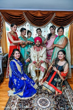Indian groom surrounded by his Indian female relatives Indian groom surrounded by his Indian female relatives