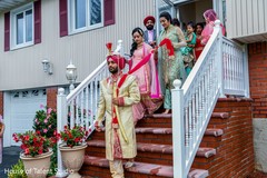 Indian groom leaving his house followed by his Indian family Indian groom leaving his house followed by his Indian family