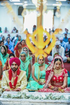 Indian couple sitting side by side during the ceremony Indian couple sitting side by side during the ceremony