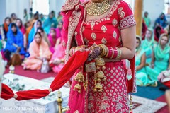 Maharani holding the Indian groom's scarf during the ceremony Maharani holding the Indian groom's scarf during the ceremony