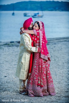 Indian couple embraces in front of the ocean Indian couple embraces in front of the ocean
