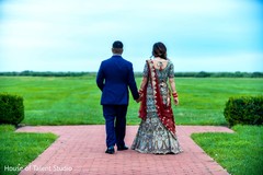 Indian couple walking away hand in hand Indian couple walking away hand in hand