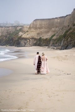 Indian couple walking by the white sand beach. Indian couple walking by the white sand beach.