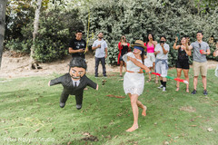 Indian bride hitting a grooms pinata. Indian bride hitting a grooms pinata.