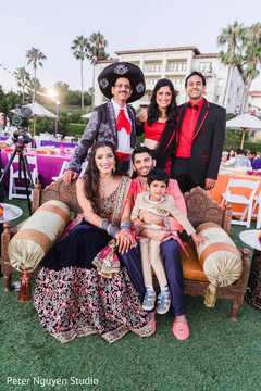 Indian bride and groom posing outdoors with friends. Indian bride and groom posing outdoors with friends.