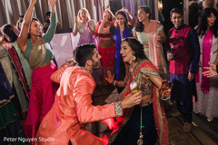 Indian couple dancing at their sangeet party. Indian couple dancing at their sangeet party.