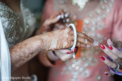 Indian bridal putting on her white diamonds bracelet. Indian bridal putting on her white diamonds bracelet.