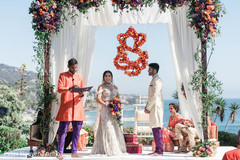 Indian couple with flower Ganesha Puja in between decoration. Indian couple with flower Ganesha Puja in between decoration.