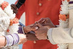 Indian groom putting ring to bride. Indian groom putting ring to bride.