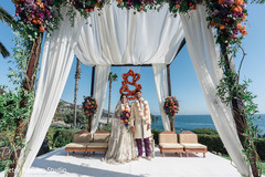 Indian couple posing at their outdoors mandap. Indian couple posing at their outdoors mandap.
