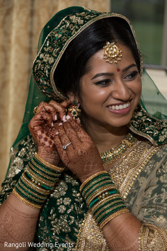 Indian bride getting her earrings on. Indian bride getting her earrings on.