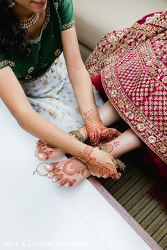 Indian bridal getting on her golden anklets . Indian bridal getting on her golden anklets .
