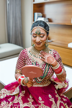 Maharani looking at her kundan polki choker. Maharani looking at her kundan polki choker.