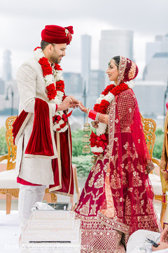 Indian bride and groom during the ring exchange ritual. Indian bride and groom during the ring exchange ritual.