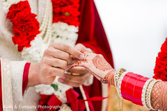 Indian groom putting wedding ring to bride. Indian groom putting wedding ring to bride.
