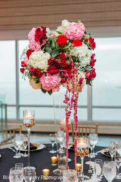 Indian wedding reception table pink, red and white flowers decor. Indian wedding reception table pink, red and white flowers decor.