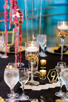 Indian wedding table candles with gold chunks decorations. Indian wedding table candles with gold chunks decorations.